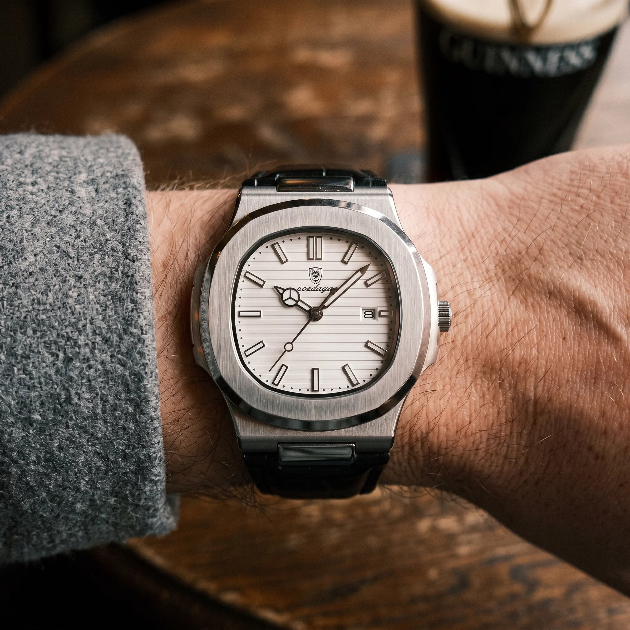 Kron Atlas watch on wrist, Dublin pub interior, top-down view