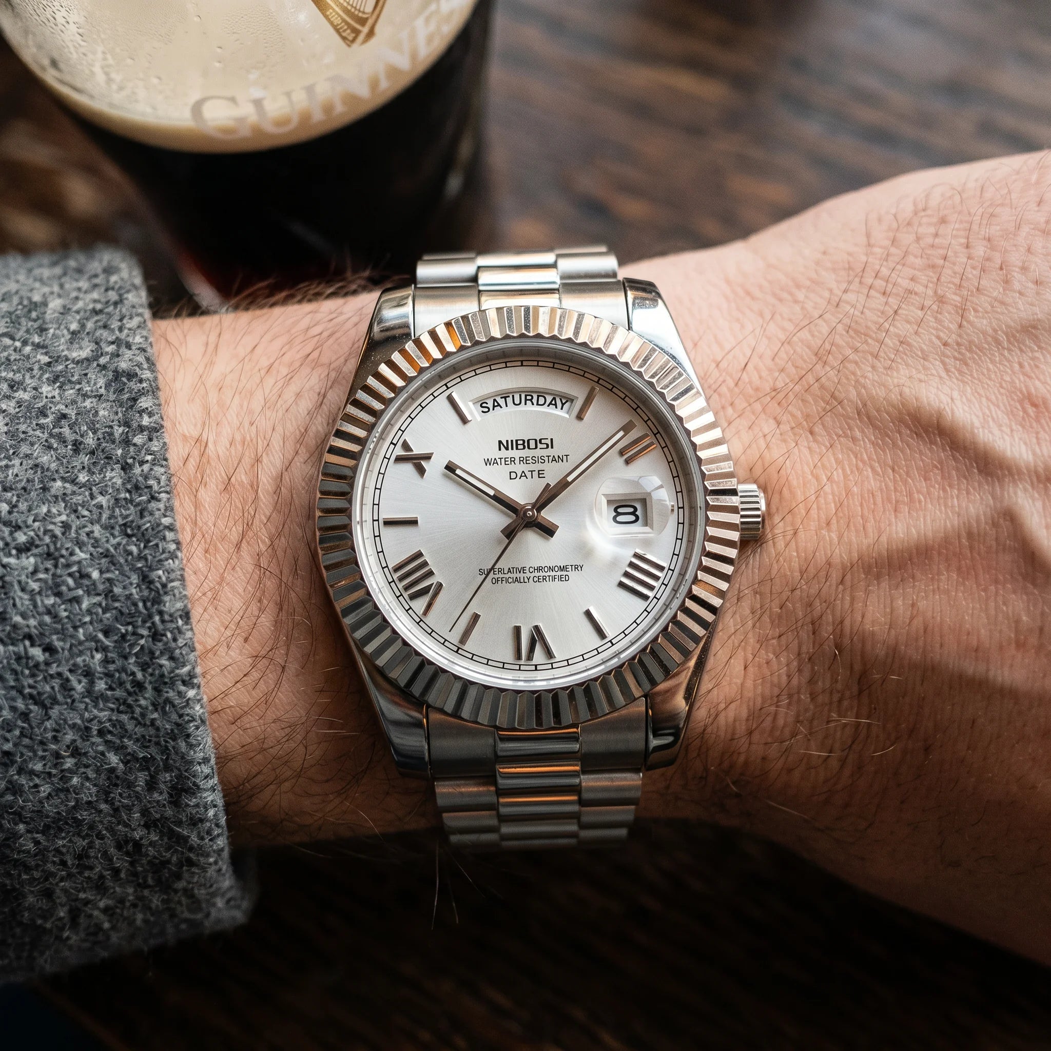 Kron Trafalgar watch on wrist, Dublin pub interior, top-down view
